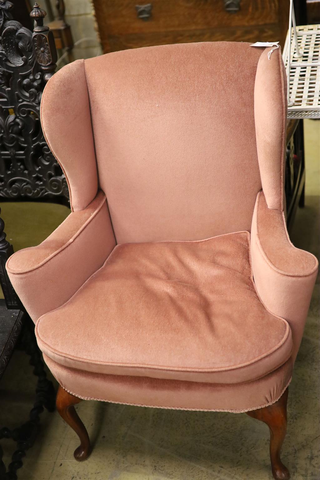 A Queen Anne style wing armchair upholstered in pink dralon, width 82cm, depth 66cm, height 101cm